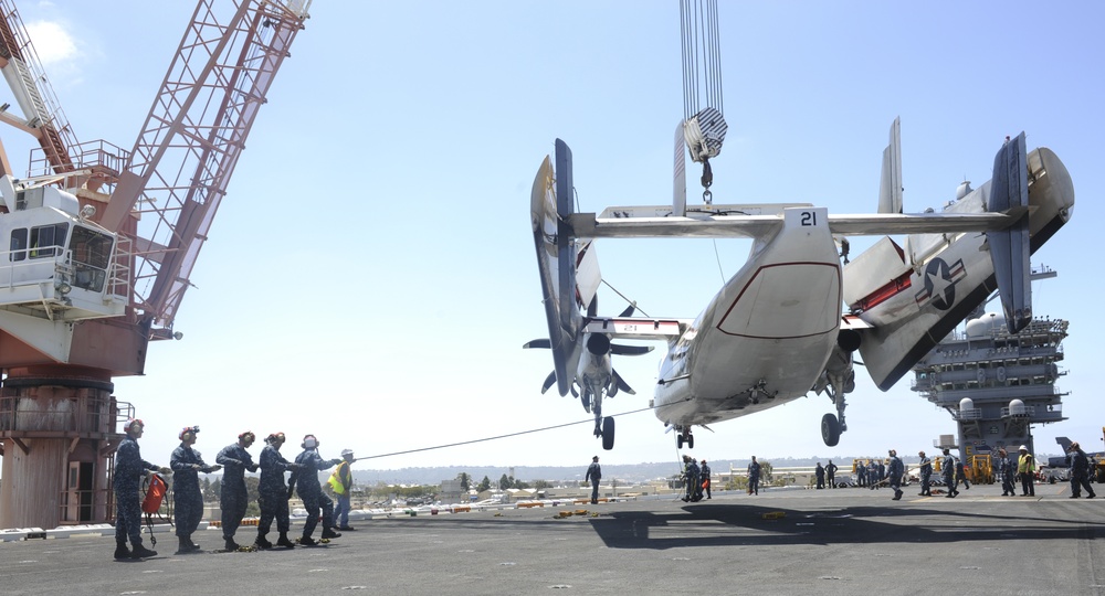 Greyhound lifted by crane from the aircraft carrier USS Nimitz