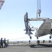 Greyhound lifted by crane from the aircraft carrier USS Nimitz