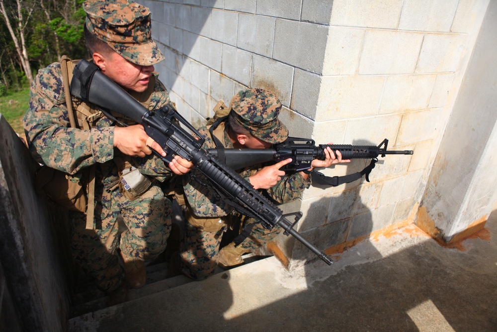 Marines patrol through urban terrain