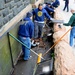 USS Frank Cable sailors clean moats