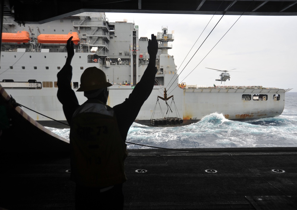 USS George Washington sailor gives signal