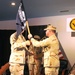 Capt. Kevin Bertelsen, commanding officer Camp Lemonnier accepts the Camp Lemonnier pennant from Capt. Scott Hurst