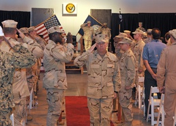 Captain Kevin Bertelsen, commanding officer Camp Lemonnier, salutes as he walks thought the sideboys at the Camp Lemonnier change of command ceremony