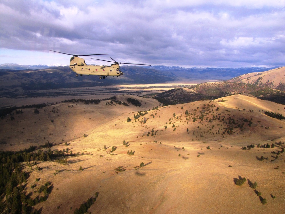 Chinook flies over pass