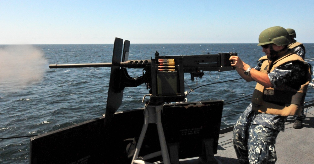 USS Underwood sailor fires machine gun