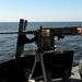 USS Underwood sailor fires machine gun