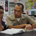 USS Emory S. Land sailors tutors students