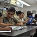 USS Emory S. Land sailors tutors students