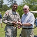 Retired general receives coin from former aide