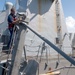 USS James E. Williams sailor repairs light