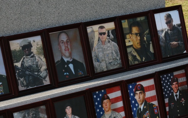 Photos of fallen paratroopers rest at the base of memorial