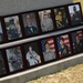 Photos of fallen paratroopers rest at the base of memorial