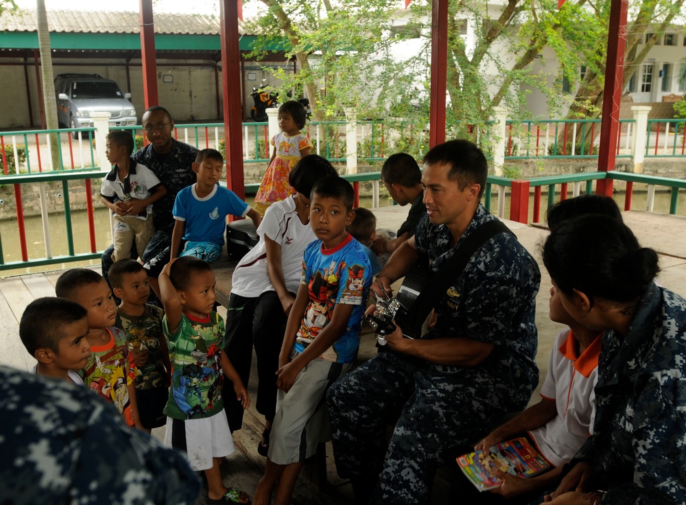 Sailors visit and play with children in Thailand