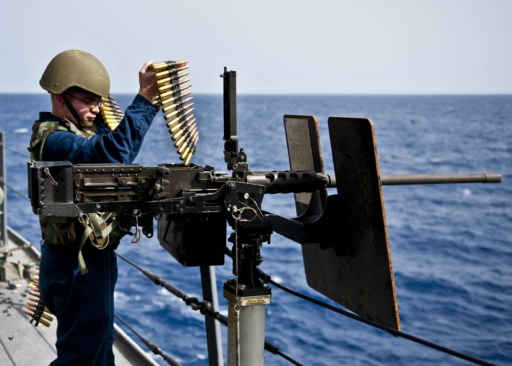 USS New York sailor loads machine gun