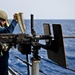 USS New York sailor loads machine gun
