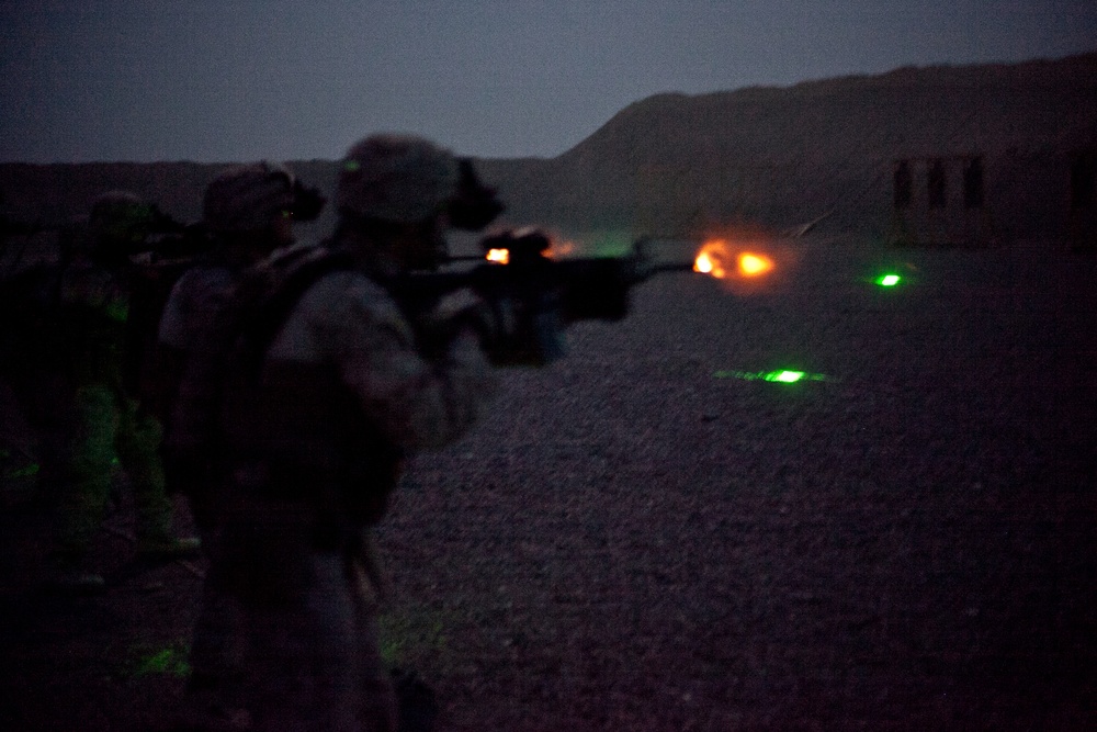 Marines shoot rifles on night range