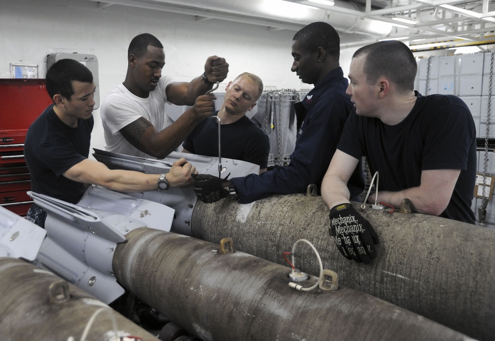 Tightening a tail fin on a GBU-16 laser-guided bomb