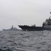 USS Decatur passes USS Iowa in the Pacific