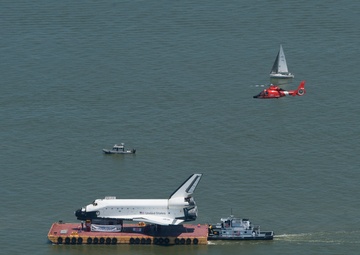 Coast Guard escorts a NASA training shuttle to the Nassau Bay Hilton Hotel dock in League City