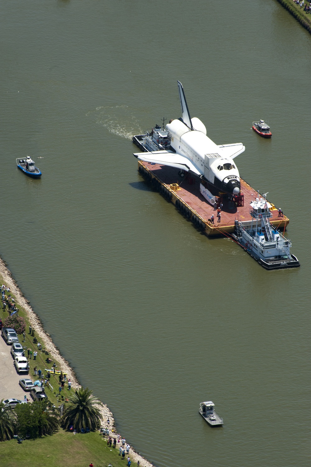 Coast Guard escorts a NASA training shuttle to the Nassau Bay Hilton Hotel dock in League City