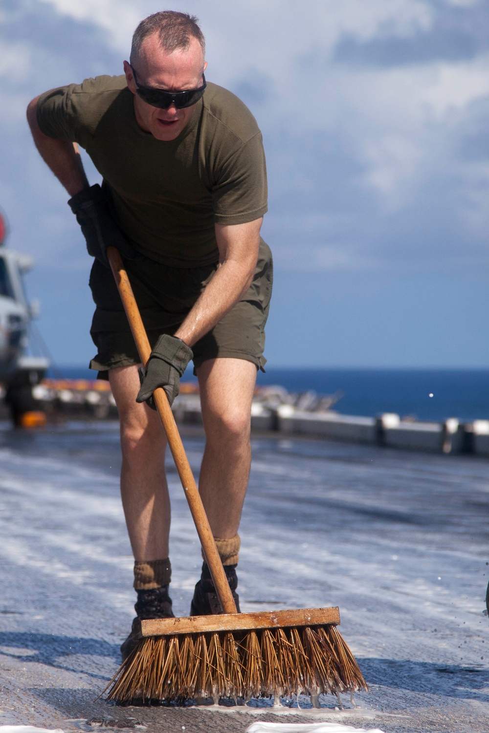 Marines, sailors wash USS Makin Island's flight deck