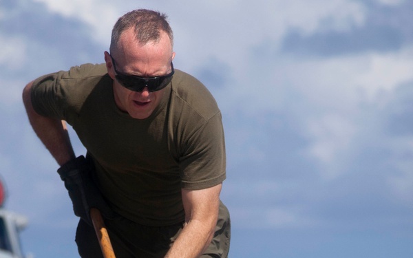 Marines, sailors wash USS Makin Island's flight deck