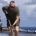 Marines, sailors wash USS Makin Island's flight deck