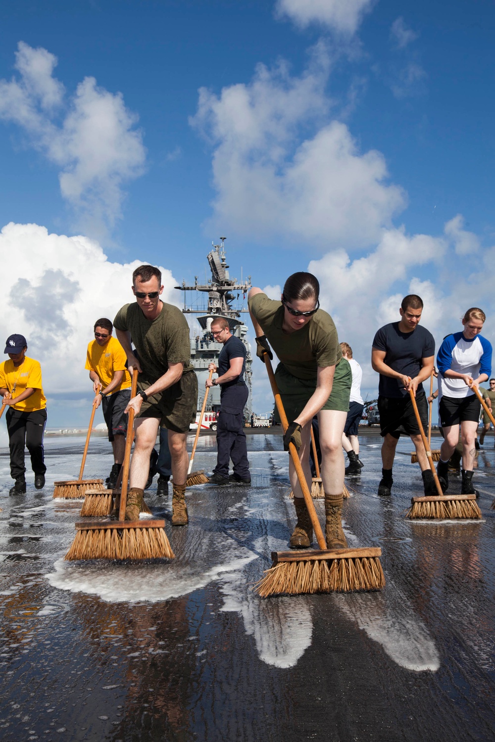 Marines, sailors wash USS Makin Island's flight deck