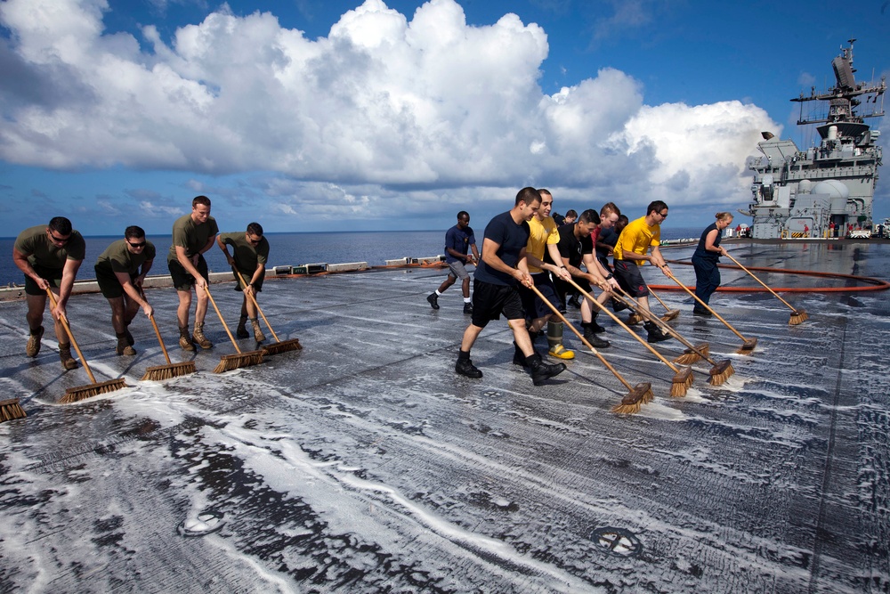 Marines, sailors wash USS Makin Island's flight deck