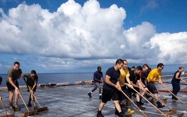 Marines, sailors wash USS Makin Island's flight deck