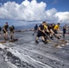 Marines, sailors wash USS Makin Island's flight deck