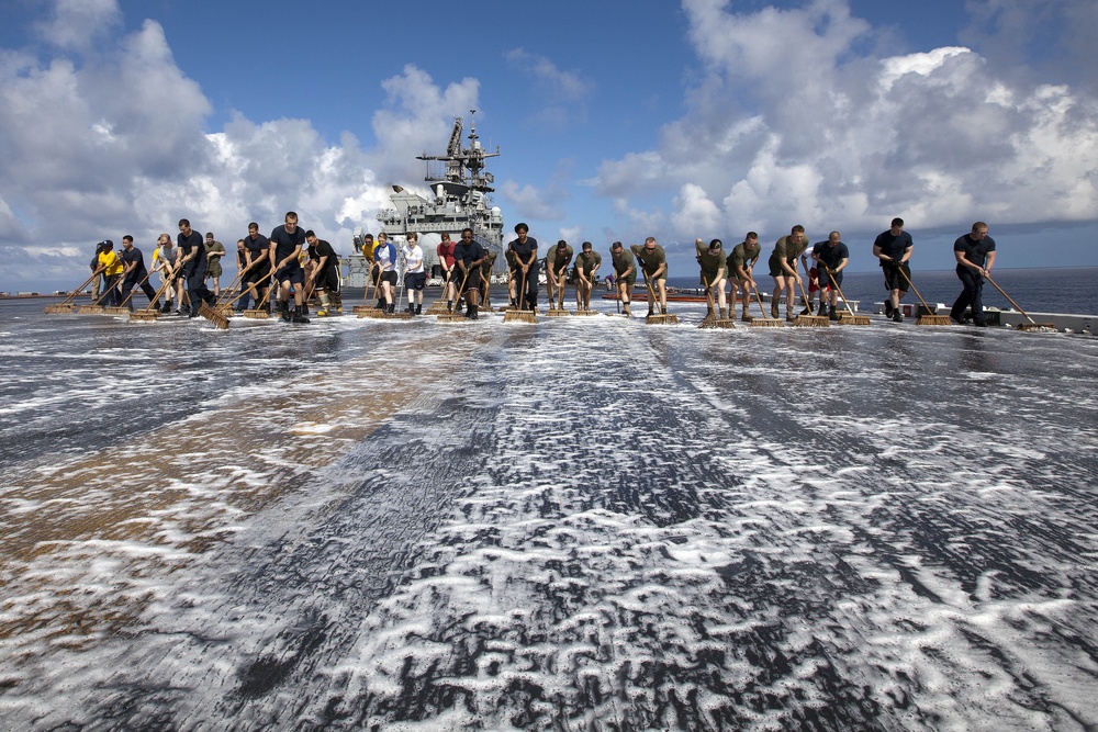 Marines, sailors wash USS Makin Island's flight deck