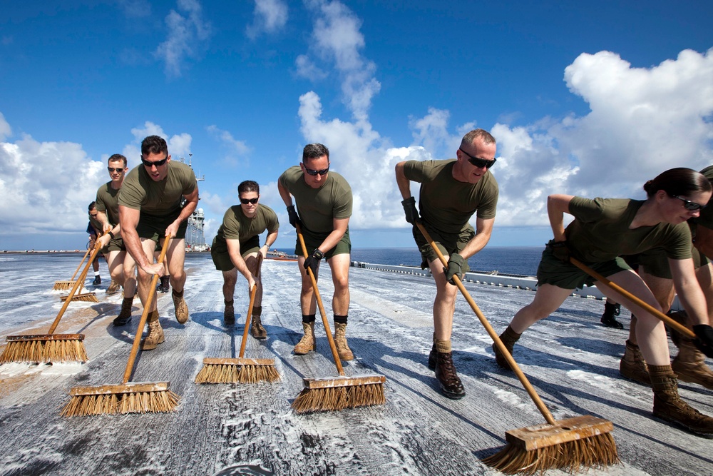 Marines, sailors wash USS Makin Island's flight deck