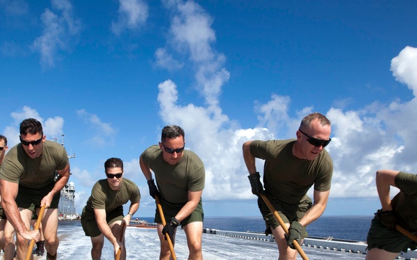 Marines, sailors wash USS Makin Island's flight deck