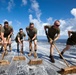 Marines, sailors wash USS Makin Island's flight deck