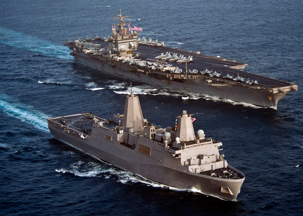 USS New York transits alongside USS Enterprise