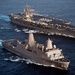 USS New York transits alongside USS Enterprise