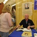 Medal of Honor recipient signs book