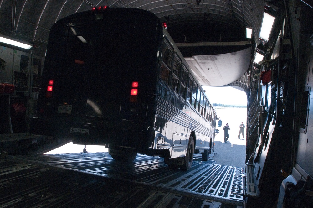 Airmen download bus from C-17