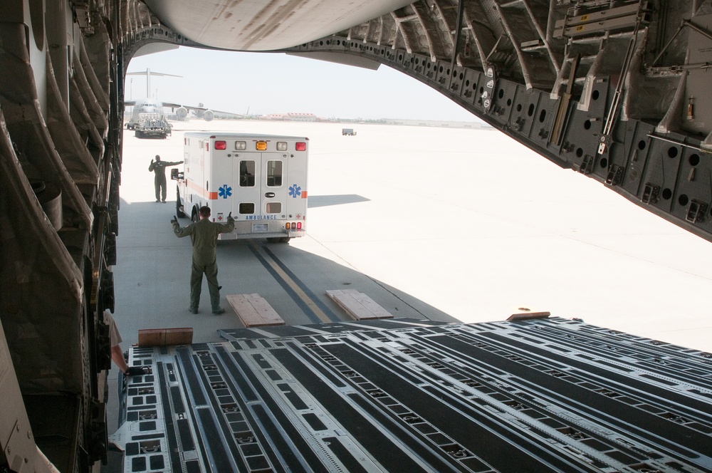 Airmen load an ambulance onto C-17