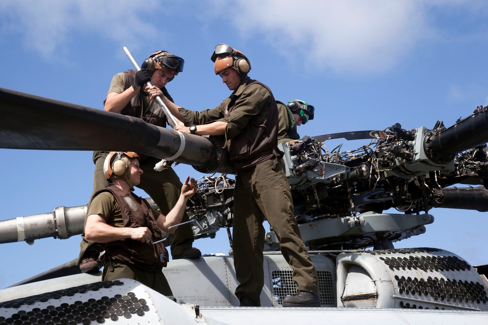 Marines maintain a Super Stallion while deployed