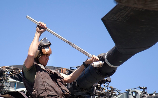 Marines maintain a Super Stallion while deployed