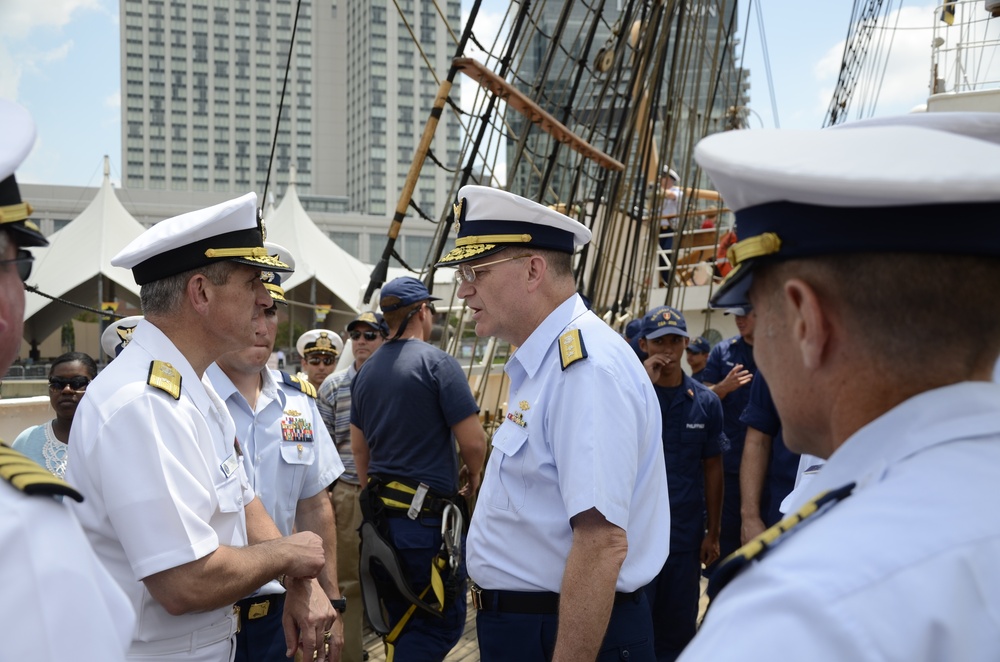 Commander, Navy Carrier Strike Group 2, chats with Commander, Coast Guard District 5