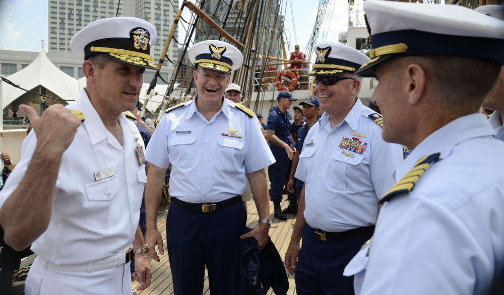 Coast Guard Rear Adm. Steve Ratti and Navy Rear Adm. Greg Nosal enjoy a social moment together