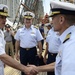 Commander, Carrier Strike Group 2 greets a Coast Guard officer aboard Barque Eagle