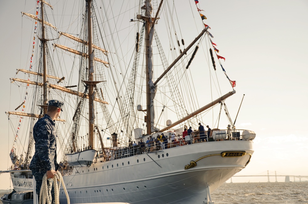 Navy Engineman 1st Class Sewel Baskett stands ready on the bow of a U.S. Naval Academy launch passes a mooring line