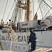 Navy boat crewmember passes a line