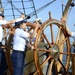 Coast Guard Academy cadets, under the direction of a Coast Guardsman, steer the U.S. Coast Guard Barque Eagle