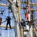 Coast Guardsmen work aloft above the deck