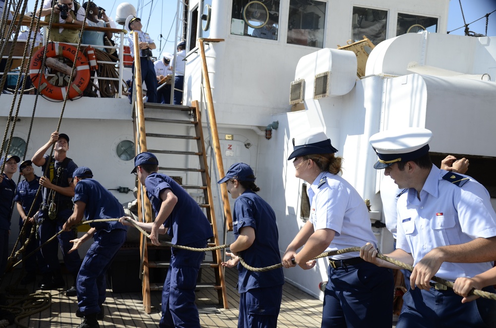 Teamwork heaving a line to hoist the main sail aboard Coast Guard Barque